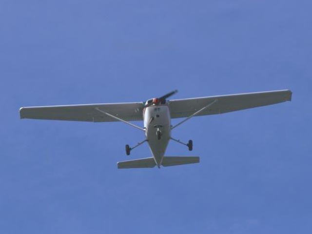 High-wing prop aircraft in flight