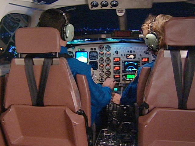 Rear view of NASA pilots on research flight