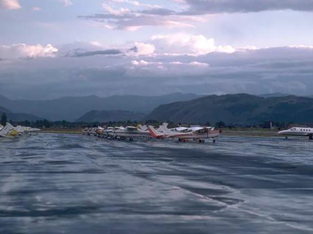 Aircraft on tarmac in mountainous area