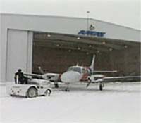 Aircraft being towed from hangar
