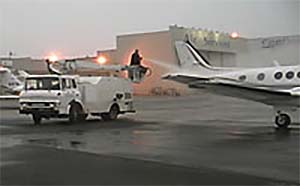 Aircraft undergoing de/anti-icing spray