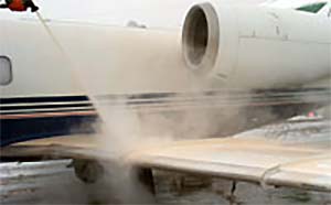 Aircraft undergoing de/anti-icing spray