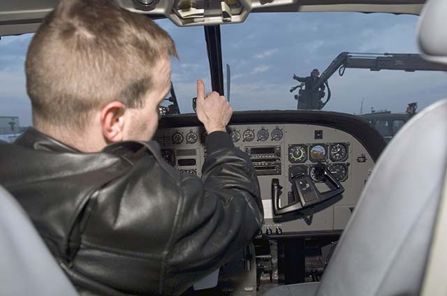 Pilot communicates with ground crew using hand signals