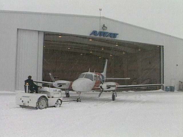 Backing turboprop into hangar during a storm