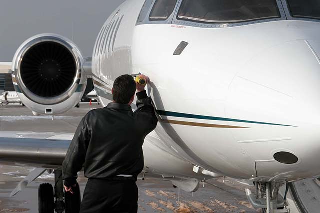 Pilot inspects aircraft sensors
